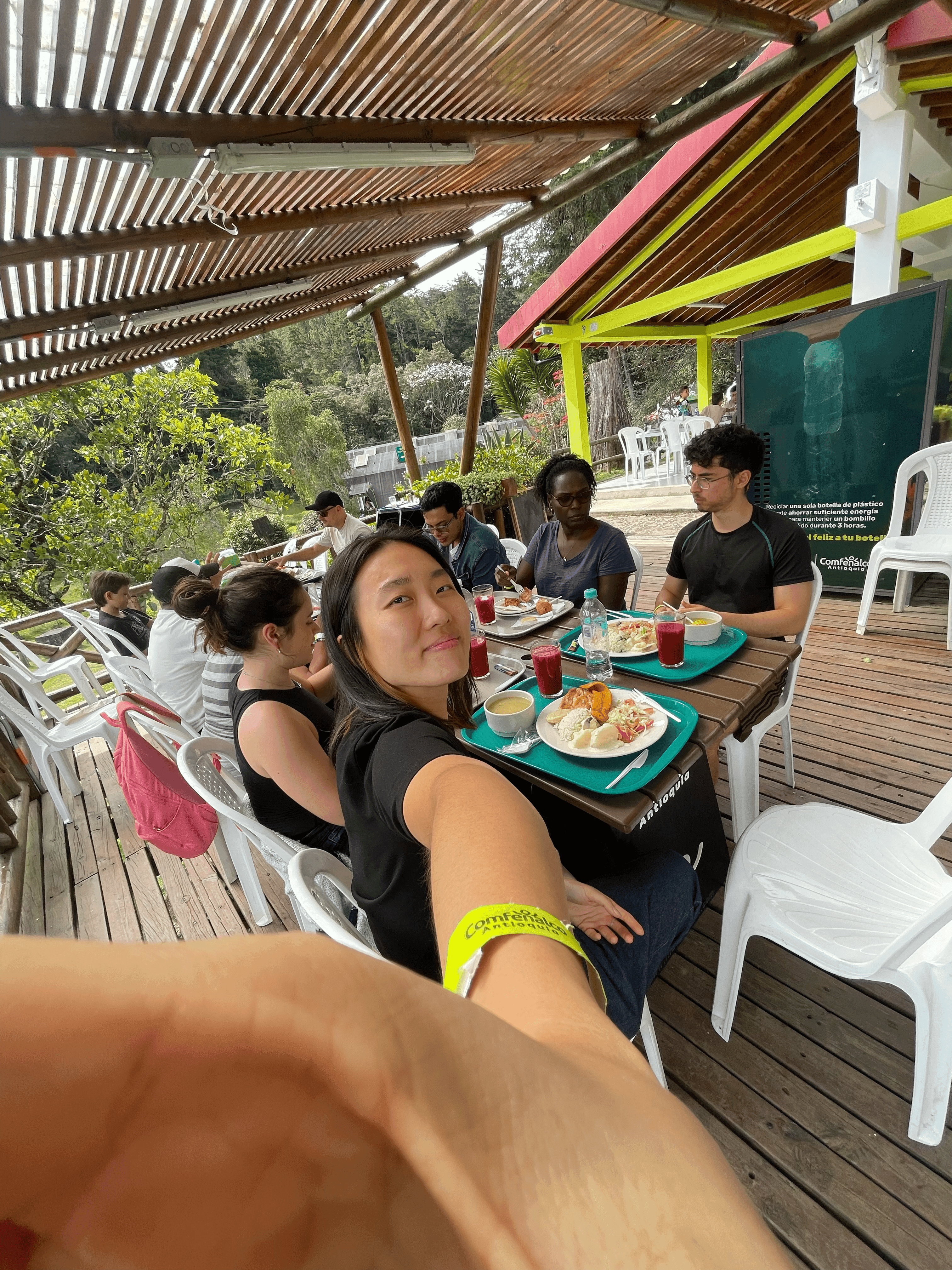 Attendees sharing lunch together at a long outdoor table