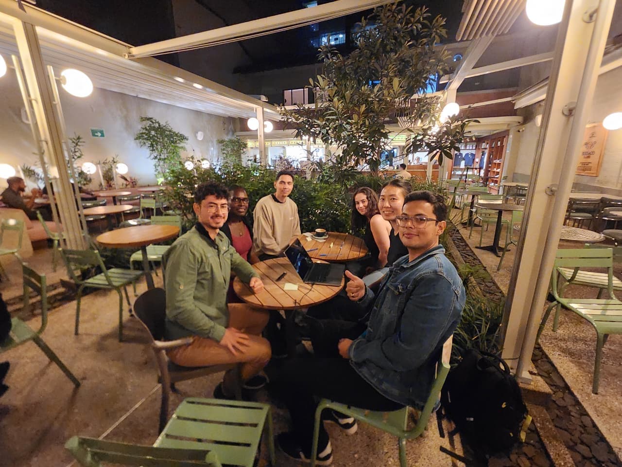 Six attendees sitting around one table together at an evening event